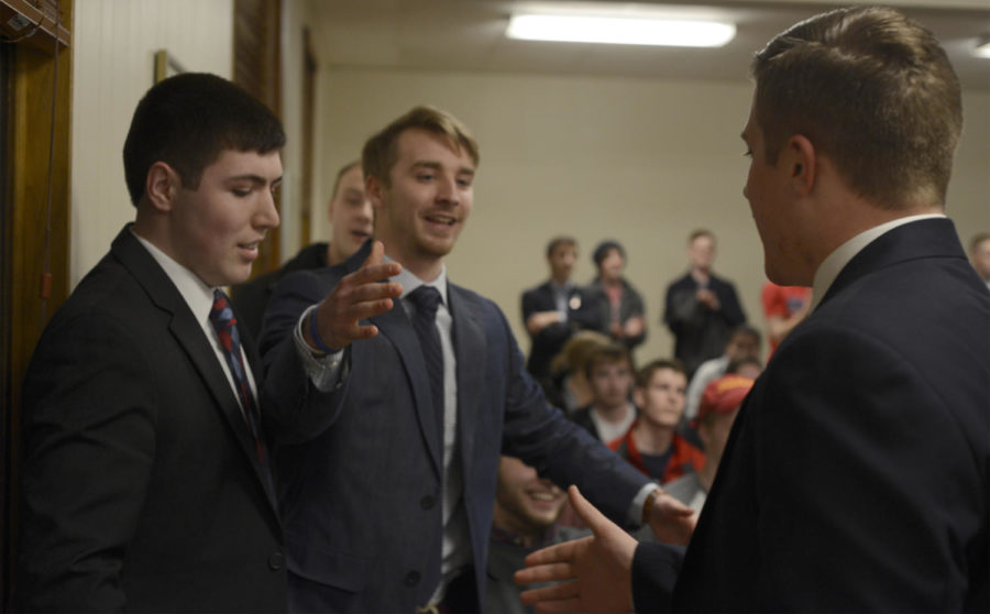 Zackary Reece congratulates Cody West (L) and Cole Staudt (R) after they win the presidential and vice presidential positions of Student Government on March 4.