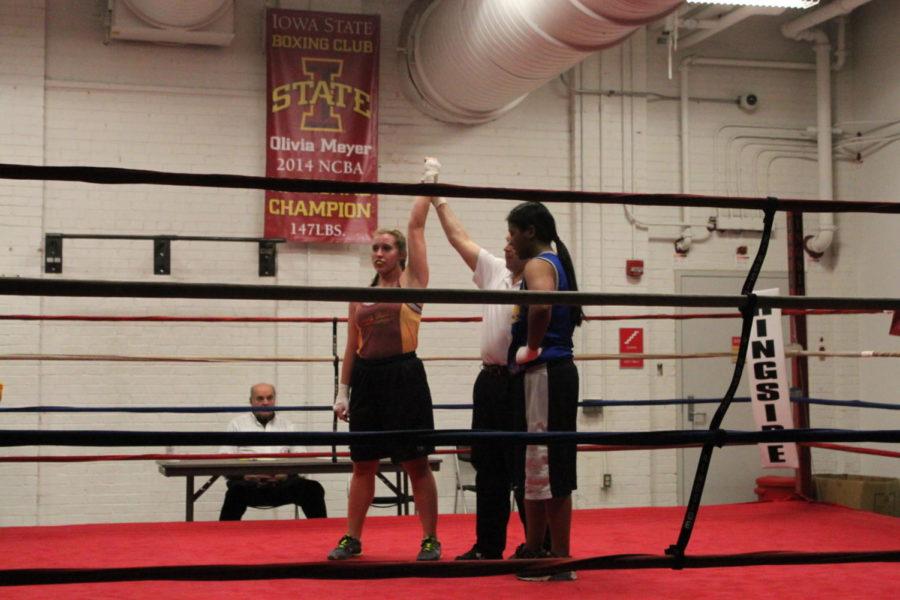 Camryn Linsters hand being raised after beating her opponent in two rounds