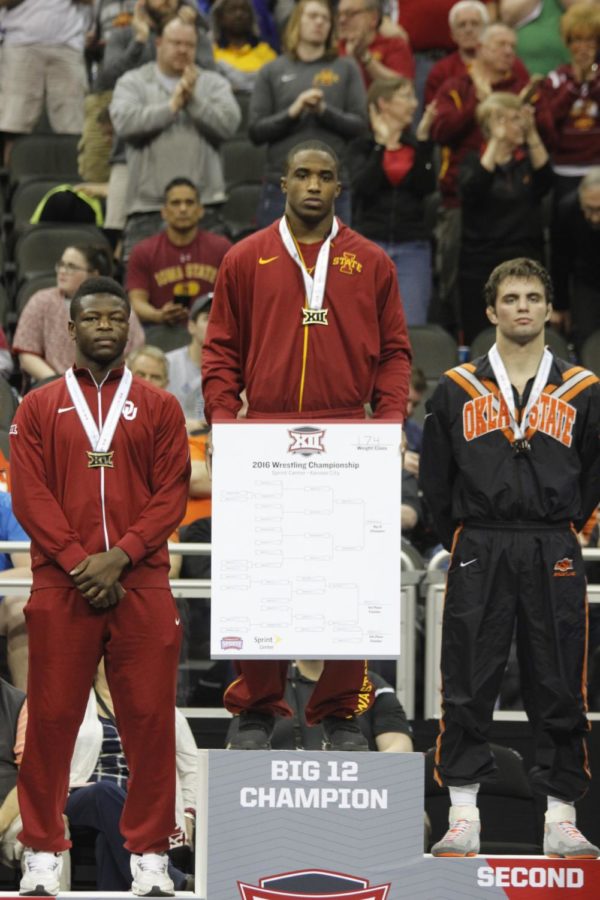 Redshirt junior Lelund Weatherspoon stands on top of the podium as the Big 12 champion at the 174-pound weight class on March 6. Weatherspoon holds the bracket of the 174-pound class as he poses for a picture. 