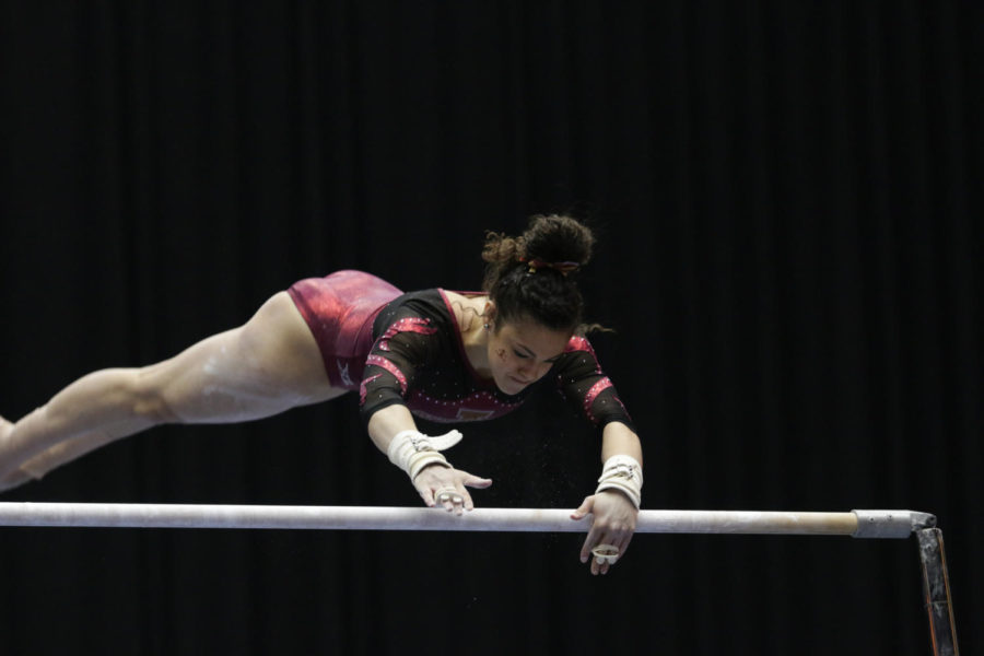 Sophomore Hilary Green performs her uneven bars routine during the quad meet at Hilton Coliseum. Iowa State played host to North Carolina State, Nebraska, and University of Wisconsin-La Crosse Feb. 21, and would go on to place third with a combined score of 194.9. 