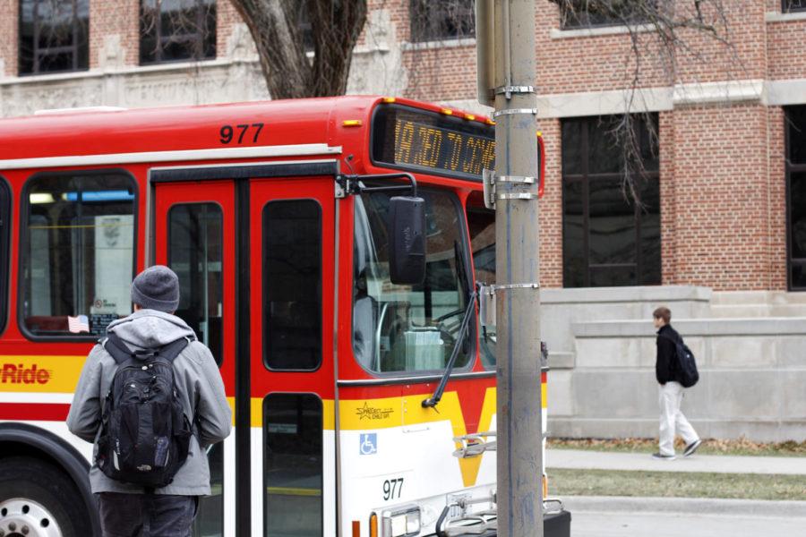 A student waits to get on CyRide, the public transit system available to students in Ames.