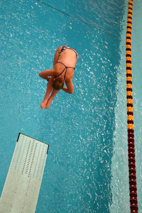 Iowa State freshman Maggie James performs a dive. The Iowa State swim team hosted the annual Cy-Hawk swim meet at Beyer Hall Fri. night. The Hawkeyes would go on to win every event, contributing to the teams 190-93 win. 