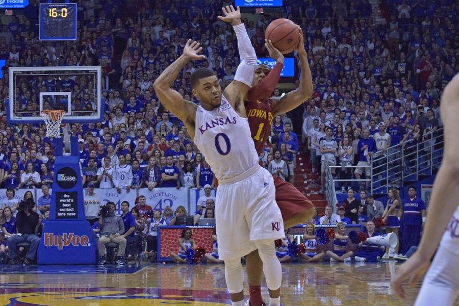 Monté Morris goes up for a shot against Kansas Frank Mason III, drawing a foul and slightly injuring his shoulder on March 5, 2016 at Phog Allen Fieldhouse in Lawrence, Kansas.