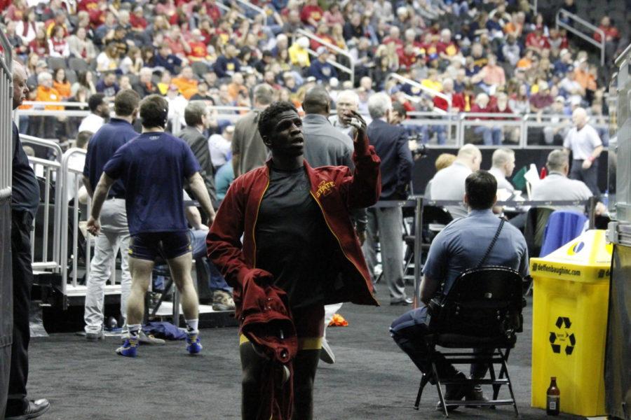Senior Earl Hall points to a couple Iowa State fans at the Sprint Center in Kansas City as he walks into the tunnel on March 5. Hall placed second in the 133-pound weight class for the Big 12 Wrestling Championships. 