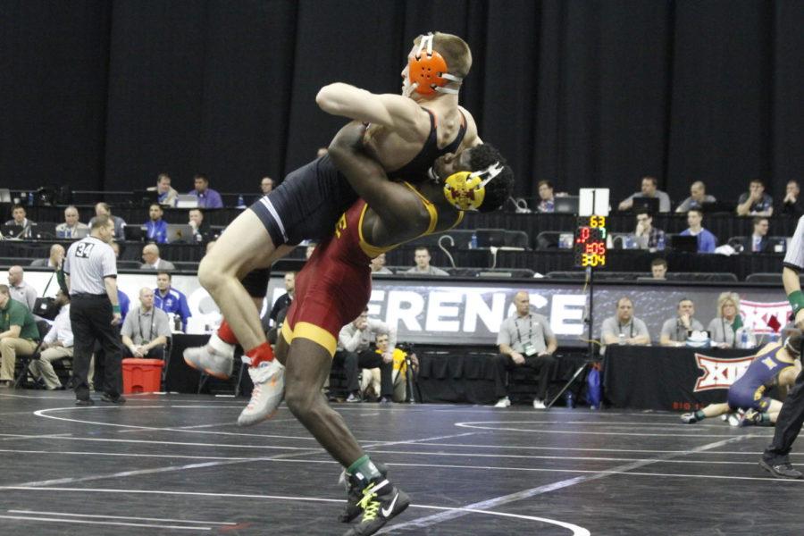 Senior Earl Hall throws his opponent up in the air before he gets the takedown. Hall earned second place at the Big 12 Championship for the 133-pound weight class on March 6. 