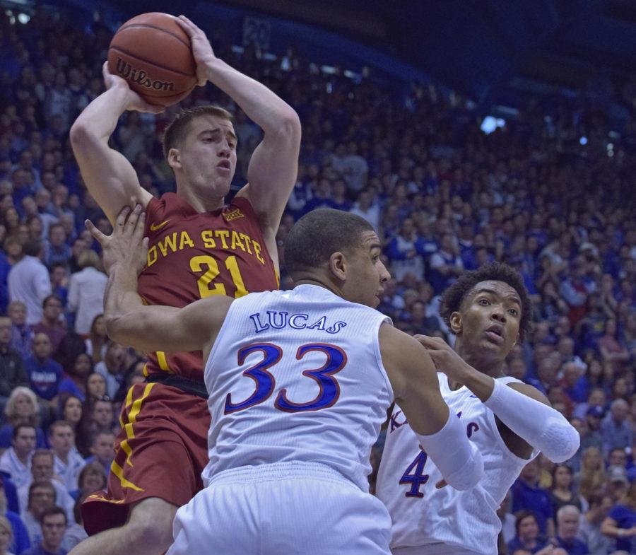 Matt Thomas looks to pass the ball against Kansas on March 5, 2016 at Phog Allen Fieldhouse in Lawrence, Kansas.