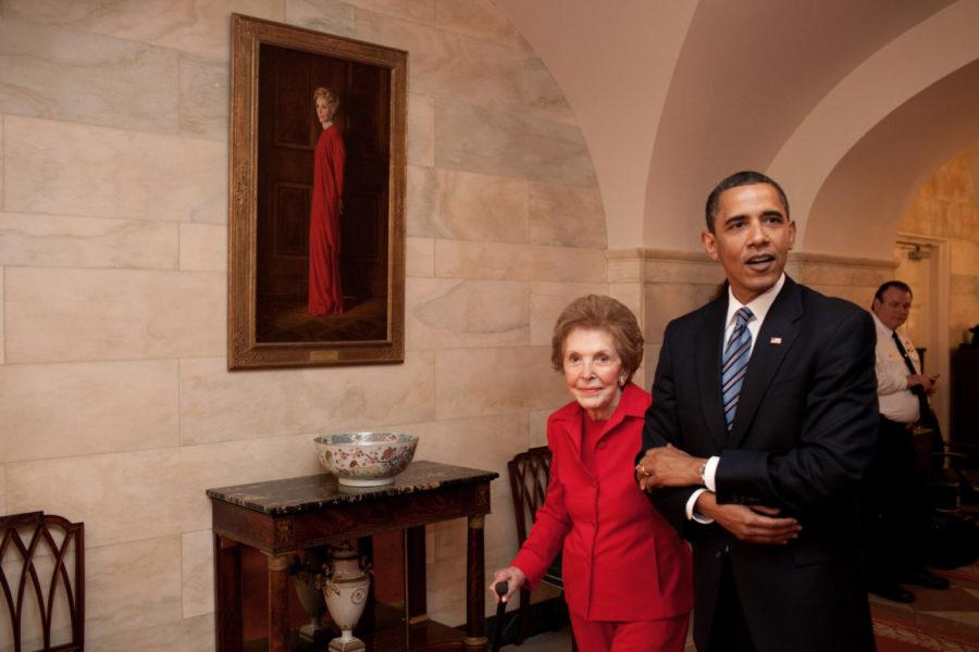 President Barack Obama and former First Lady Nancy Reagan walk side-by-side through Center Hall in the White House, June 2, 2009. To the left of Mrs. Reagan hangs her official White House portrait as First Lady. 