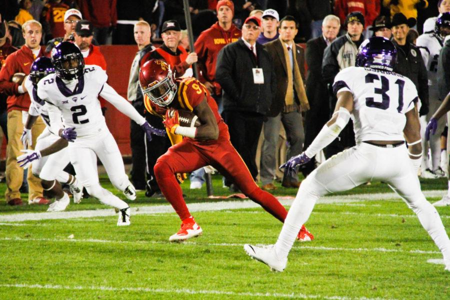 Wide receiver Quenton Bundrage runs past TCU defenders during a game against TCU on Saturday. The Cyclones would go on to lose 45-21. 