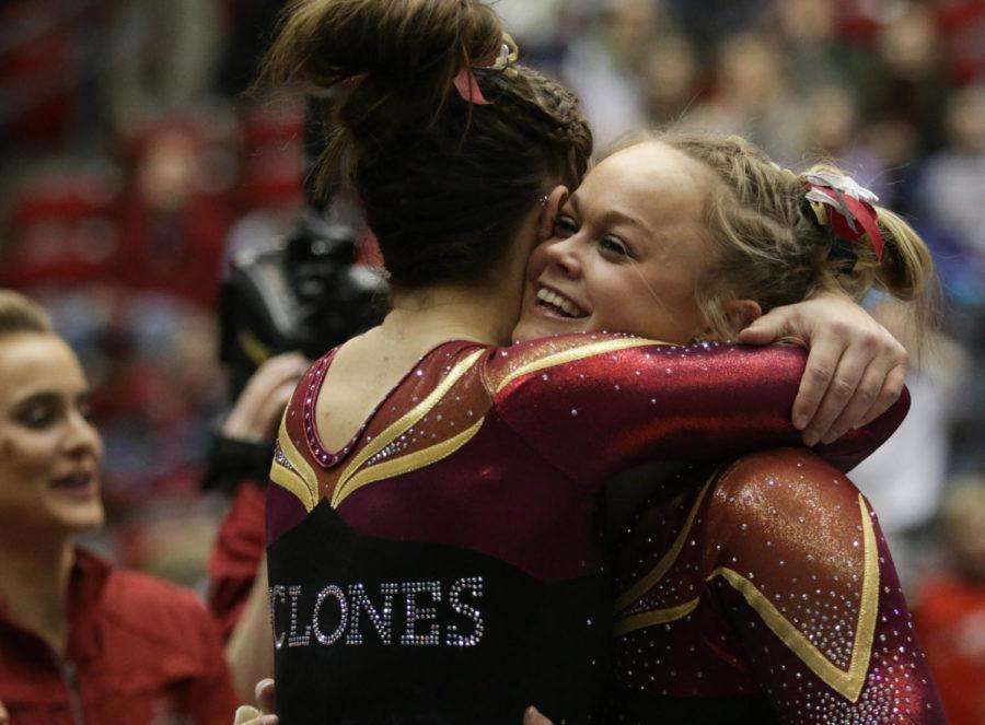 Sophomore Haylee Young (right) hugs freshman Meaghan Sievers after her floor exercise routine during the meet against Iowa. Youngs score of 9.925 clinched the Cyclones victory over the Hawkeyes. 