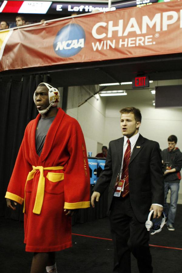 Redshirt sophomore Kyven Gadson walks out before his match sporting his fathers old wrestling robe with his name on the left arm and Gadsons father, Willie, on the right, during the third day of the NCAA Wrestling Championships on March 23, 2013, at Wells Fargo Arena in Des Moines, Iowa. Gadson finished the tournament sixth at 197 pounds.

