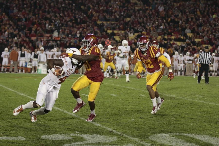 Brian Peavy (middle) and Jay Jones (right) tackle Texas wide receiver Daje Johnson in the Cyclones 24-0 win on Oct. 31.