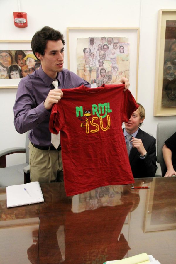 Mike Bankers, sophomore in management and industrial engineering, holds up a t-shirt that belongs to a new club, Norml ISU, during a meeting with the Senior Vice President of Student Affairs, Tim Hill, and Senior Vice President for Business and Finance, Warren Madden at Beardshear Hall on Nov. 29th. The shirt is having some controversy due to the logo of ISU mascot Cy, being used since the use of marijuana is illegal. The clubs goal is to promote change.
