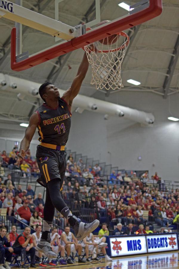 UNIs Wes Washpun throws a dunk down at the Sports Page Farewell Tour charity game on Sunday in Marshalltown, Iowa. 