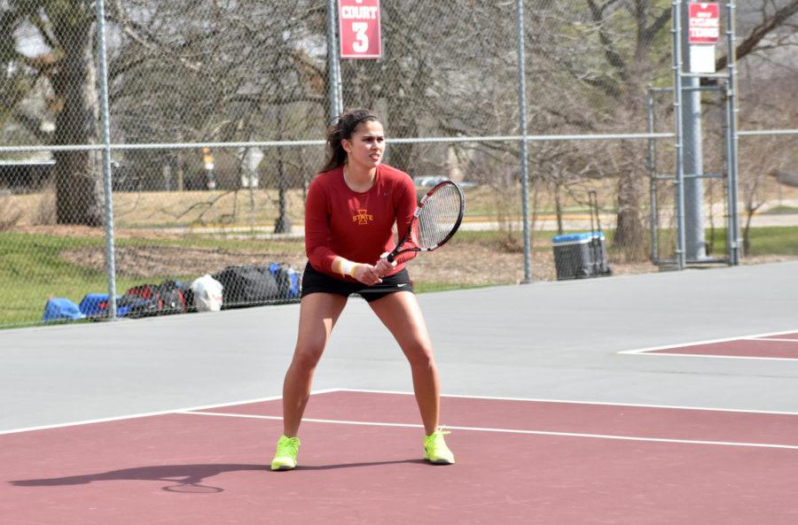 Iowa State senior Alejandra Galvis watches for the ball at the outdoor Kansas match on April 10. Galvis won her doubles match with freshman Annabella Bonadonna. The Cyclones would go on to lose overall 4-2.