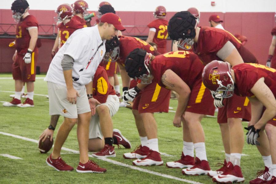 Head coach Matt Campbell helps the offensive line get set during spring football practice March 8 in the Bergstrom Football Complex. 