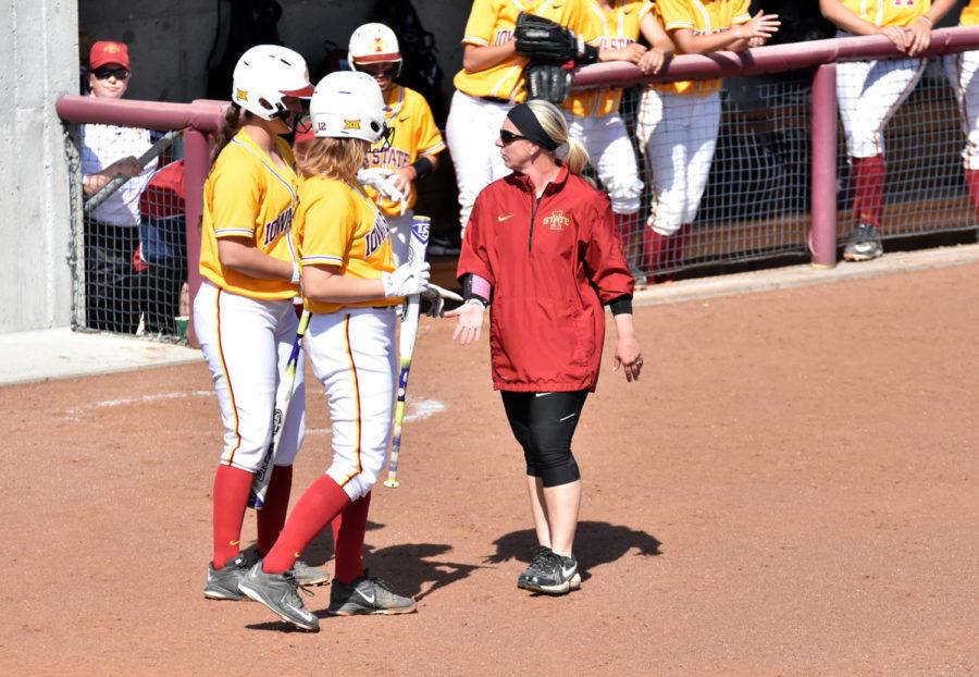 Head coach Stacy Gemeinhardt-Cesler helps players before they take bat at the game against Omaha on April 14. This is her 11th year with the Cyclones.