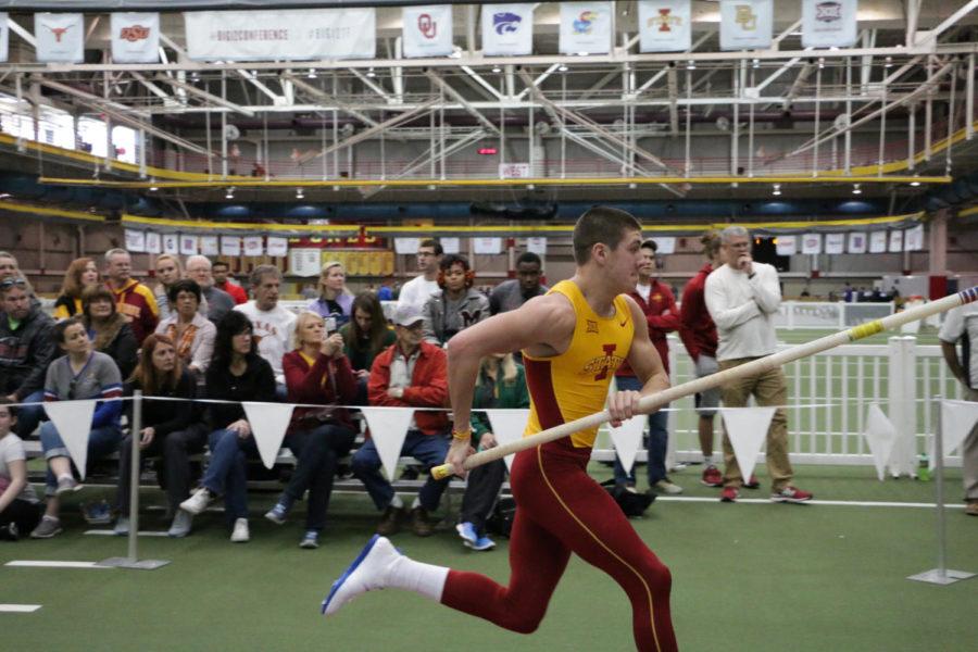 Freshman Wyatt Rhoads runs down the runway during the pole vault as part of the mens heptathalon. His father, former head football coach Paul Rhoads watches. The Big 12 Indoor Championships were held at the Lied Rec Center on Feb. 27. 