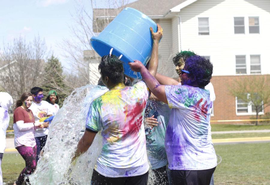 A group of students dump water on another during the Holi celebration that took place Saturday in Frederiksen Court.