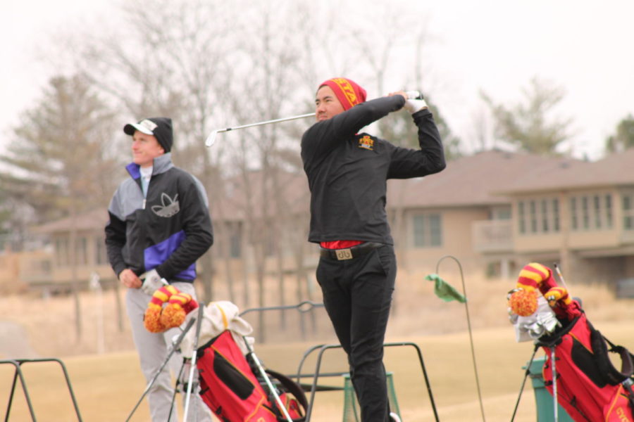 Freshmen Ruben Sondjaja, right, and Nick Voke, left, go through practice shots as the Iowa State men's golf team begins to prepare for upcoming tournaments. As the colder weather begins to subside, providing favorable conditions on the green, coach Andrew Tank lead the team through their first practice of the season at the Coldwater Golf Links southeast of campus.