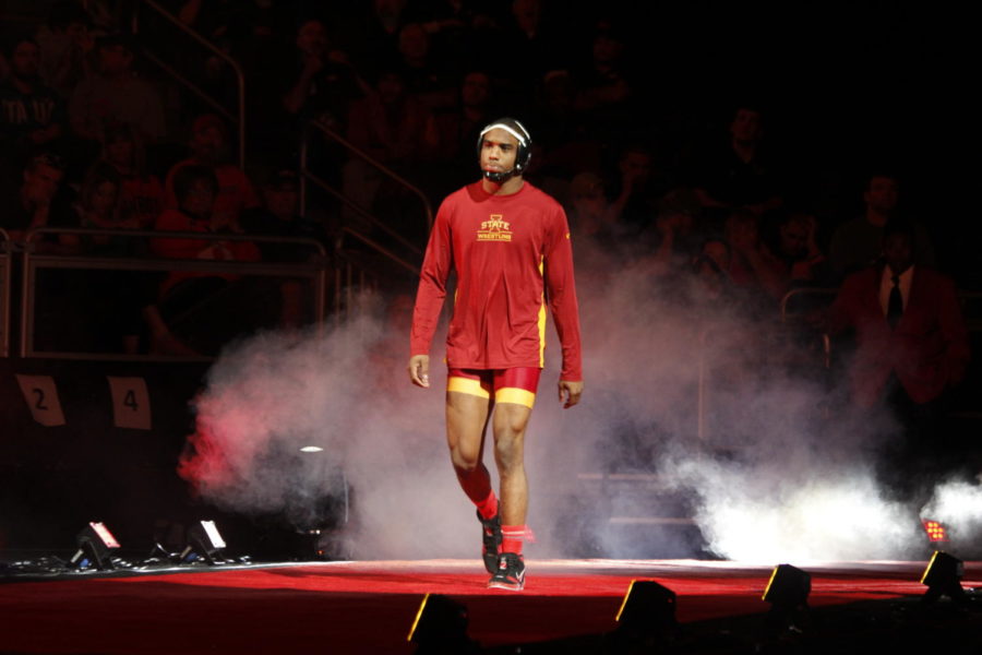 Redshirt junior Lelund Weatherspoon walks down the red carpet for his championship match in the 174-pound weight class against Oklahoma States Chandler Rogers. Weatherspoon won the match and became a two-time Big 12 Champion in his college career. 
