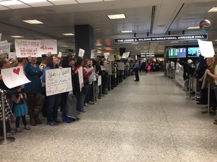 Demonstrators hold signs at the Washington Dulles International Airport protesting Donald Trumps ban on Muslim refugees Jan. 28.