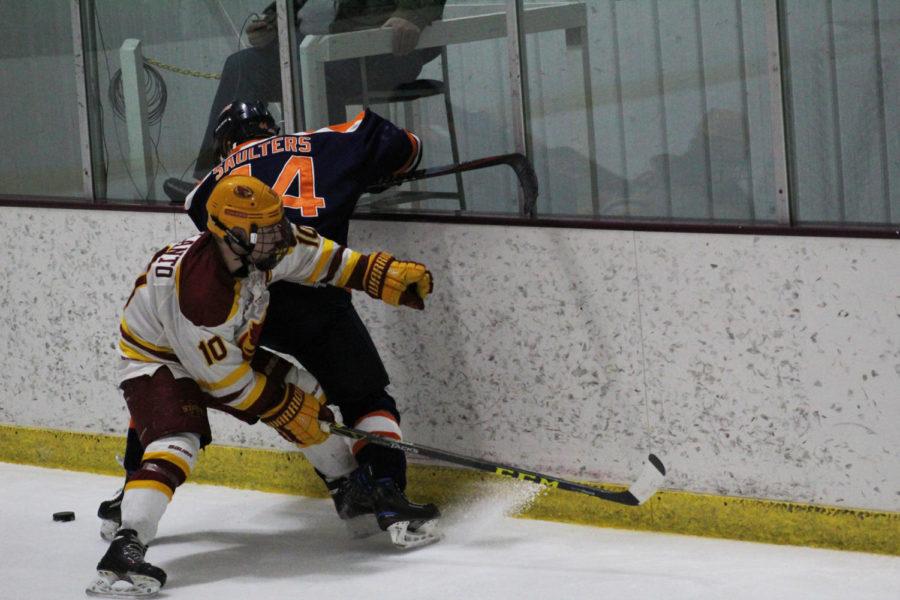 Senior defense Eero Helanto fights for the puck in the game on Jan. 13 against Illini Hockey. The Cyclones lost 4-1.