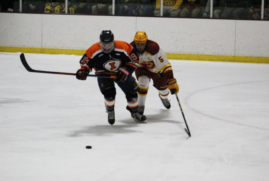 Junior defense Jake Uglem skates for the puck in the game on Jan. 13. The Cyclones went against Illini Hockey and took a loss.