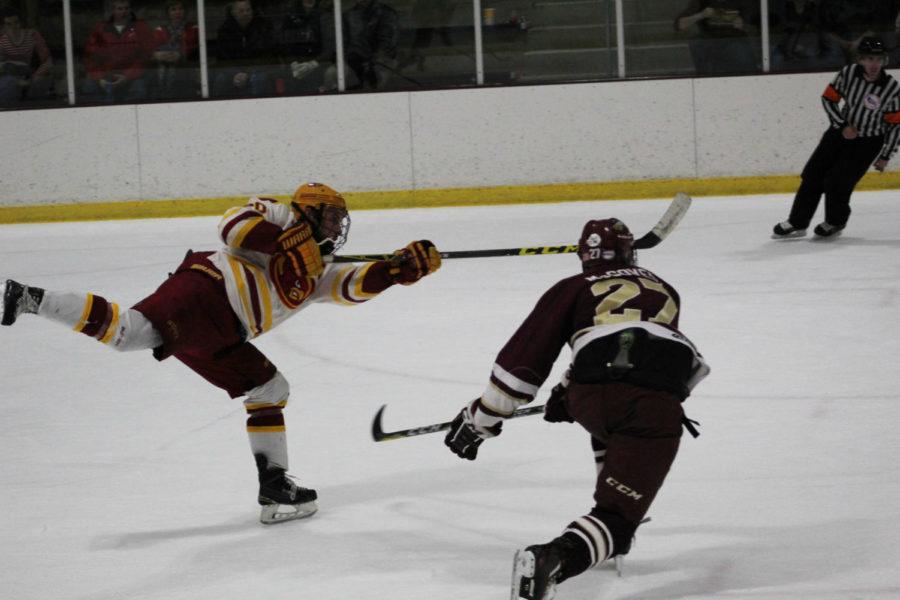 Senior forward Chase Rey shoots the puck against Robert Morris on Jan. 27. The second period ended with a tie of 1-1.