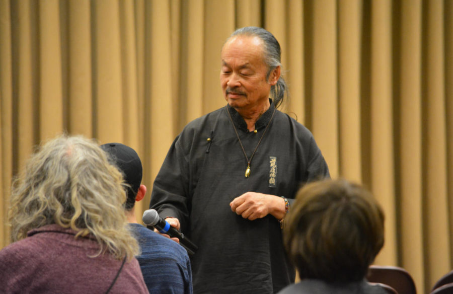 Lee Mun Wah began his interactive session on diversity by walking silently around the room looking at the audience members. Mun Wah asks an audience member how he felt when he was walking around silently. The session was held in the Sun room of the Memorial Union on Jan. 31.