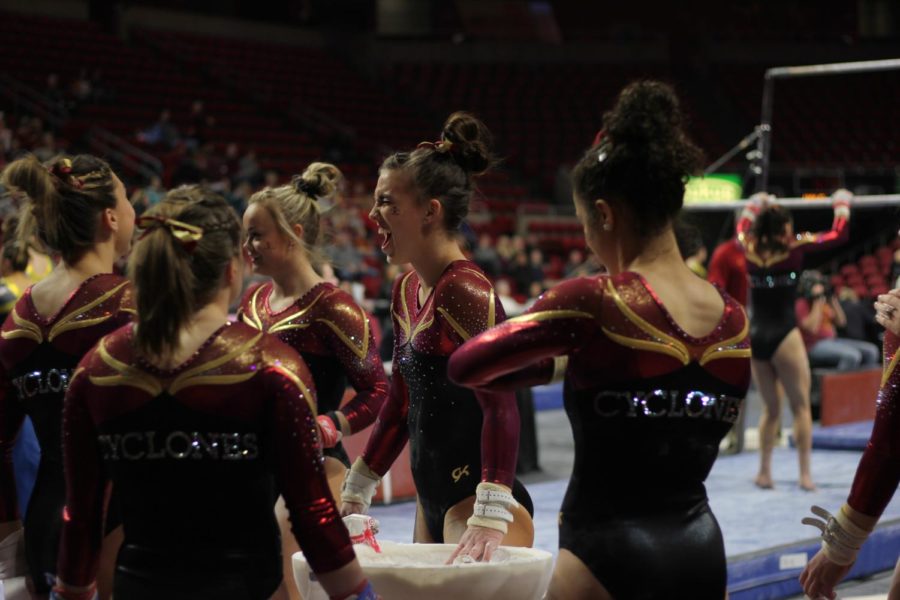 Megan Sievers laughs with her teammates on Jan. 13 in Hilton Coliseum during Iowa State gymnastics tri-meet on Jan. 13. Iowa State won the tri-meet against Towson and UW-Oskosh with a score of 194.275.
