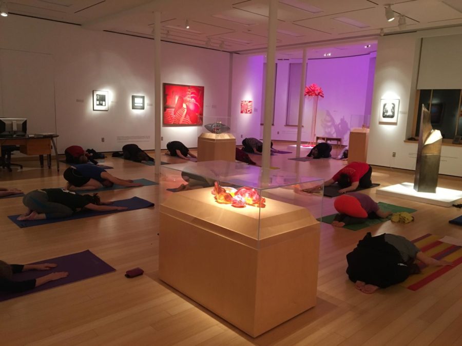 Participants go into the childs pose during Artful Yoga at the Christian Petersen Art Museum Jan. 11. 