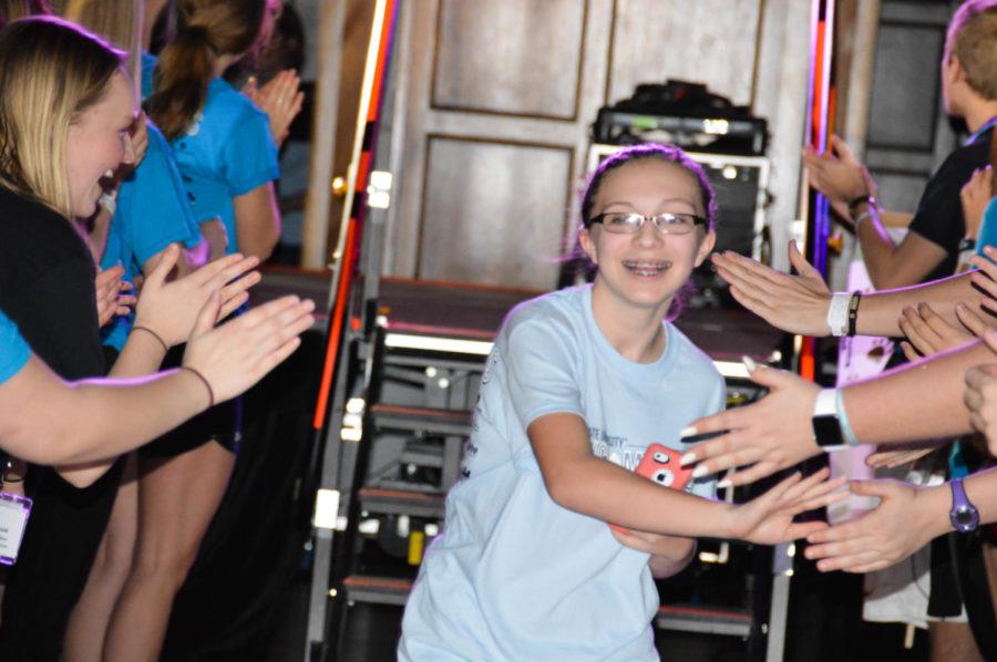 One of the miracle kids slaps hands with the crowd at Dance Marathon on Friday Jan 20. The money raised during Dance Marathon is given directly to the University of Iowa Children’s Hospital through the Children’s Miracle Network.