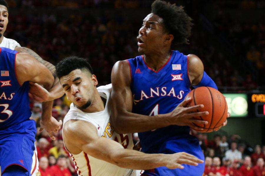 Kansas' Devonte' Graham fouls on Iowa State senior Nazareth Mitrou-Long during their game Jan. 16 at Hilton Coliseum. The No. 2 Jayhawks defeated the Cyclones 76-72.