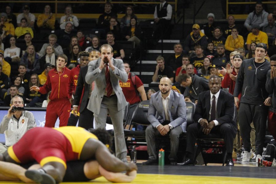 As redshirt senior Quean Smith gets the takedown, the Iowa State coaches are giving him instructions in the 10-5 heavyweight win. Iowa State lost to Iowa 26-9 on Dec. 10 in Iowa City, Iowa. 