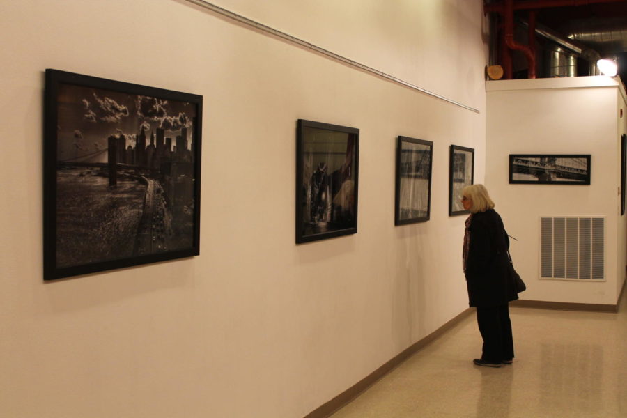 A woman looks at photojournalist Michael Corones gallery titled Gotham, which consists of both black and white and color photographs. The gallery was open this past Friday, Jan. 6 on Main Street in Ames.