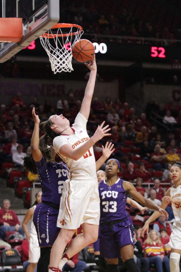 Bridget+Carleton%2C+Iowa+State+sophomore%2C+finishes+at+the+rim+with+a+reverse+layup+defended+by+TCUs+AJ+Alix.+Carleton+played+35+minutes+and+finished+with+a+Cyclone+team+high+of+24+points.