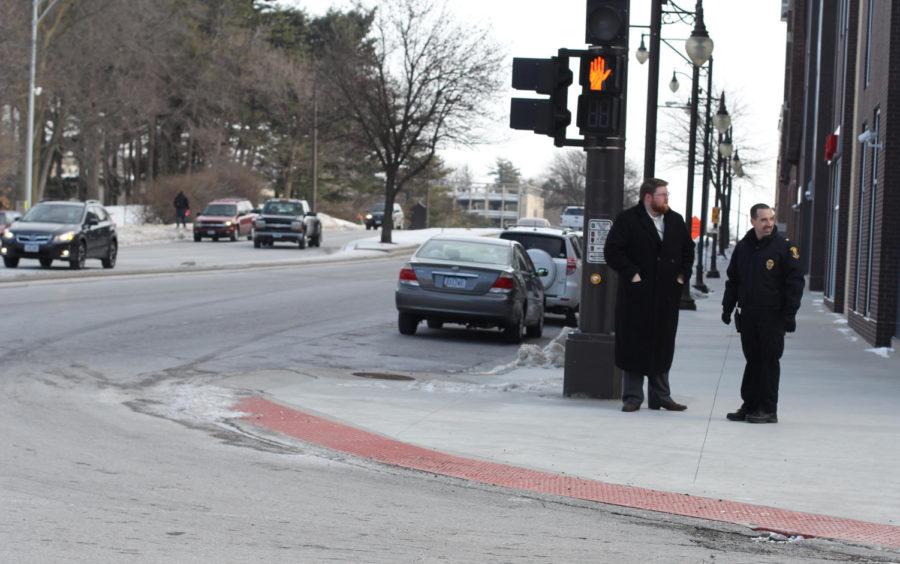 Police officers stand on the corner of Welch Avenue and Lincoln Way Jan. 11 as part of the Bike, Walk, Drive smart campaign. Officers spoke to people on the street about sharing the road, making yourself visible, always being aware, respecting each other and taking your time. 