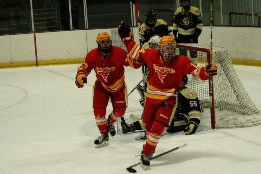 Freshmen Jackson Graalum and sophomore Jon Severson celebrate after a Cyclone goal in the second period. The Cyclones went on to beat Colorado 3-2 on Dec. 10.
