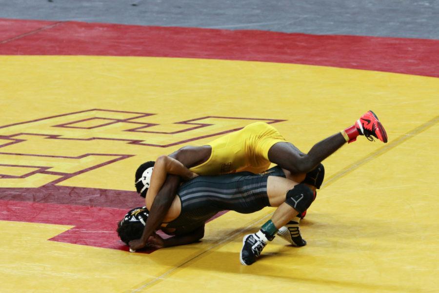 Iowa State senior Earl Hall wrestles Arizona State Jan. 6. The Cyclones hosted Arizona State at Hilton Coliseum for simultaneous gymnastics and wrestling meets, dubbed Beauty and the Beast. The gymnastics team defeated the Sun Devils 193.850-191.8, while the wrestling team lost 25-14. 