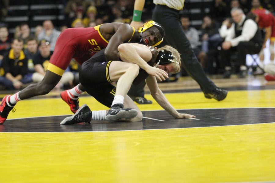 Redshirt senior Earl Hall gets on top of the Iowa wrestler early in the 133-pound match. Hall would use this early lead to win with a 5-3 final score. Iowa would defeat Iowa State 26-9 on Dec. 10 in Iowa City, Iowa. 
