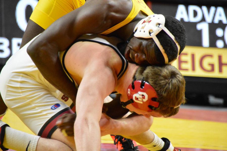Iowa State redshirt senior Earl Hall wrestles Oklahomas Trae Blackwell during The Beauty and The Beast event at Hilton Coliseum Jan. 27. Hall defeated Blackwell 4-0. 