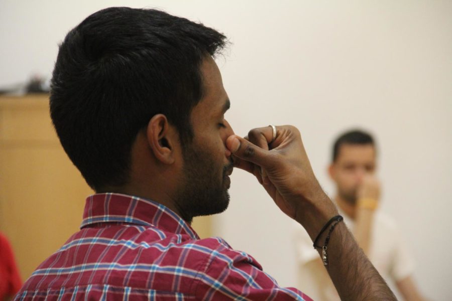 Hindu YUVA practices an alternate nostril breathing technique during a Yoga session at State Gym on Jan. 26.