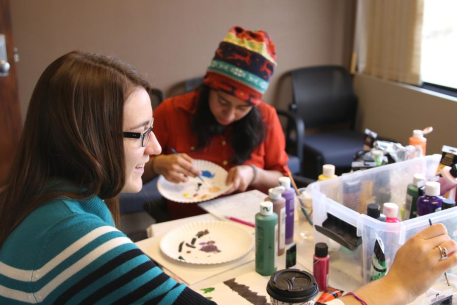Katelyn Fritz and Perla Carmenate, both apart of the WiSE Program, take study breaks by painting canvases in Carver Hall on Dec. 7 during Dead Week. The Women in Science and Engineering Program brings awareness to women in these majors and offers opportunities to network and build community. Fritz likes how laid back it is, and likes canvas painting as a study break. Like Fritz, Carmenates favorite part is the peace and that it relieves stress from tests. 