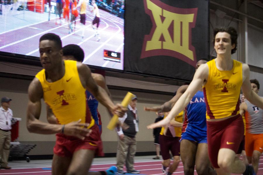 Eric Fogltanz hands off the baton to Ben Kelly in the second leg of the 400-meter relay during the Iowa State Classic on February 11 at Lied Recreational Center.