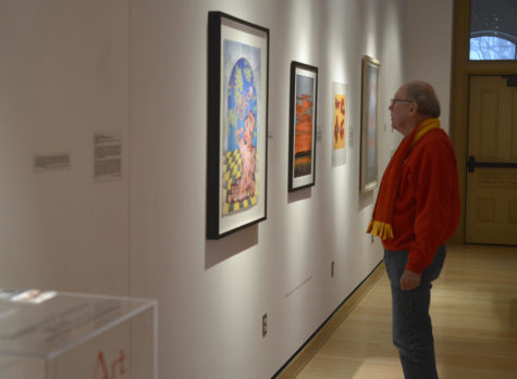 A visitor views a painting in the Christian Petersen Art Museum during the opening of the Red exhibit on Jan. 12. The exhibit explores the significance of the color red across culture and society.