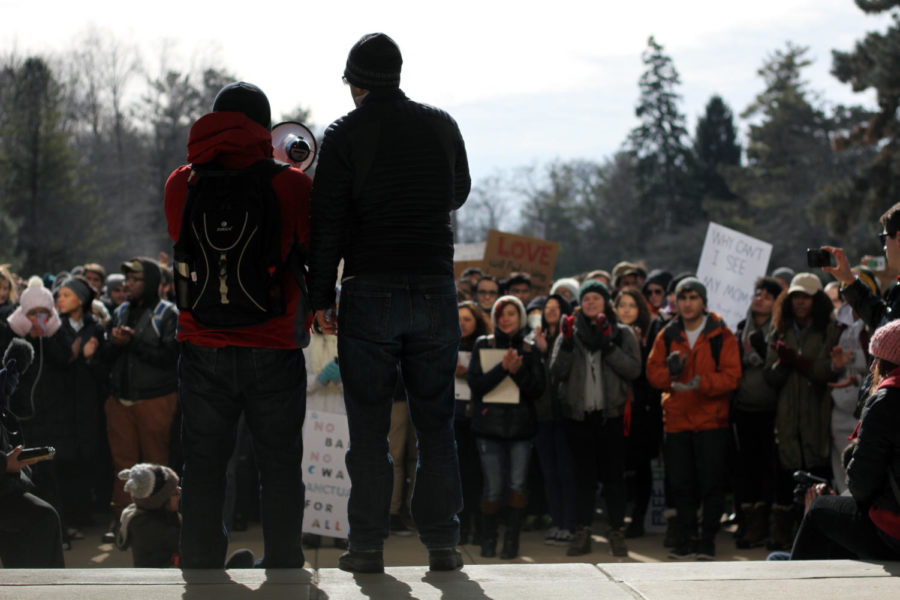 March organizer Wesley Harris (left) introduces an Iranian-American graduate student to speak about how the travel ban will affect his family and his studies during the Hoodies and Hijabs march Feb. 9, 2017. 