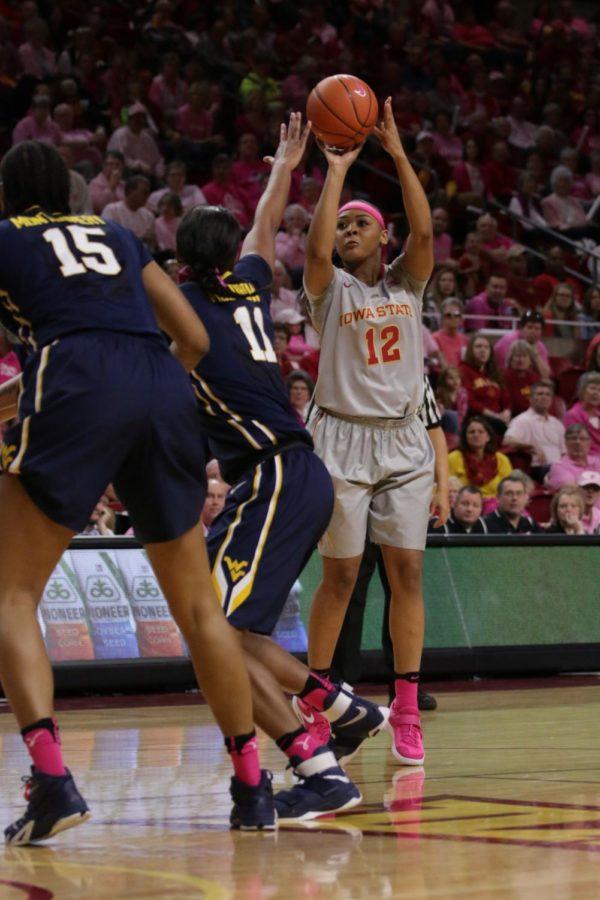 Iowa State senior, Seanna Johnson, shoots a 15 foot jumper contested by West Virginias Teana Muldrow. Johnson finished with 16 points, her 84th career game in double figures.