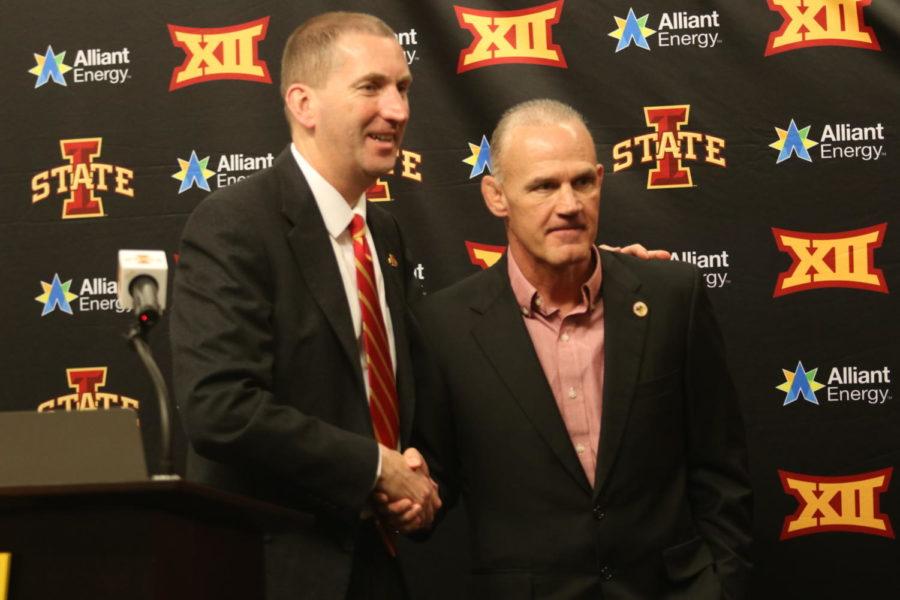 Athletic Director Jamie Pollard shakes hand with new wrestling Head Coach Kevin Dresser following his introductory press conference.