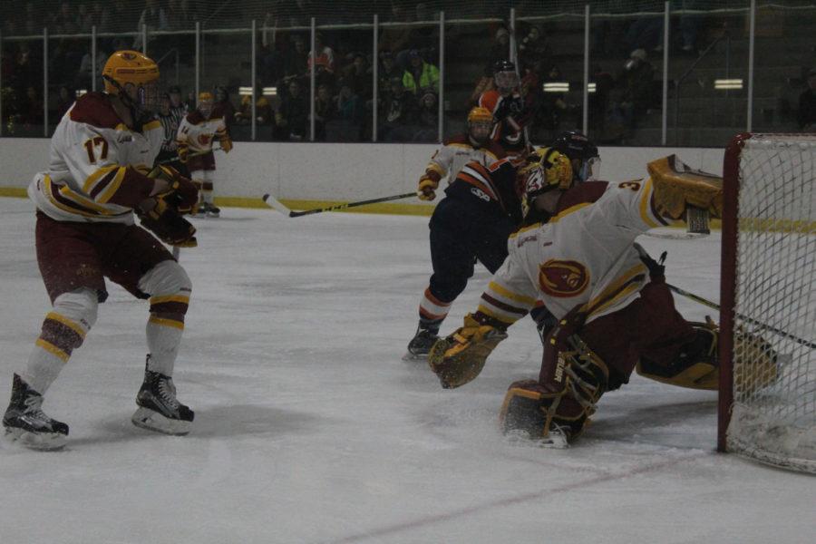 Senior goalie Derek Moser and sophomore forward Aaron Azevedo protect the goal in the game against Illini Hockey on Jan. 13. The game ended in a Cyclone loss.