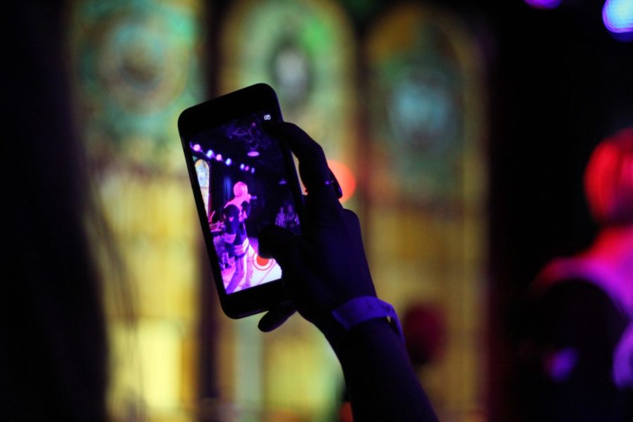 A fan takes a picture as Aaron Carter performs his new version of his hit song, "I Want Candy," on Feb. 3 in the Maintenance Shop.